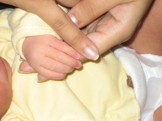 Holding mommy's finger